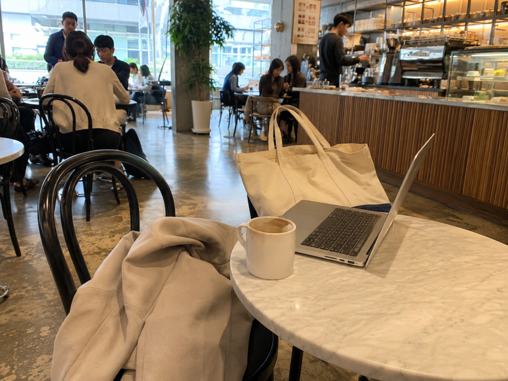 Korean cafe culture with a laptop and bag left on a table to save a seat