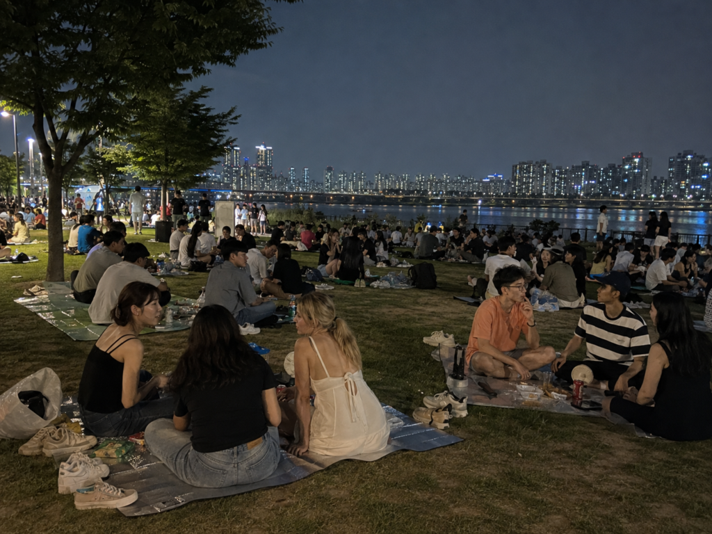 Crowds gathering at Hangang Park on a warm summer night in Seoul