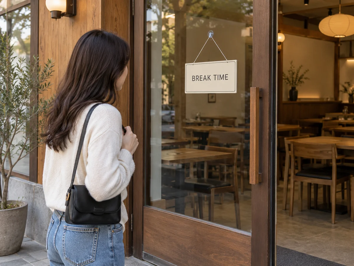 Traveler reading a BREAK TIME sign on a restaurant door.